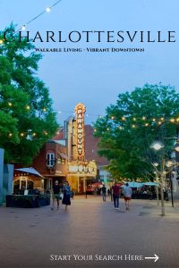 Pedestrian downtown street with lit theater marquee in Charlottesville.