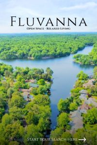 Aerial view of a lake winding through tree-lined neighborhoods in Fluvanna County.